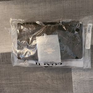 Brand new - Coach signature block tech wallet in black and brown.